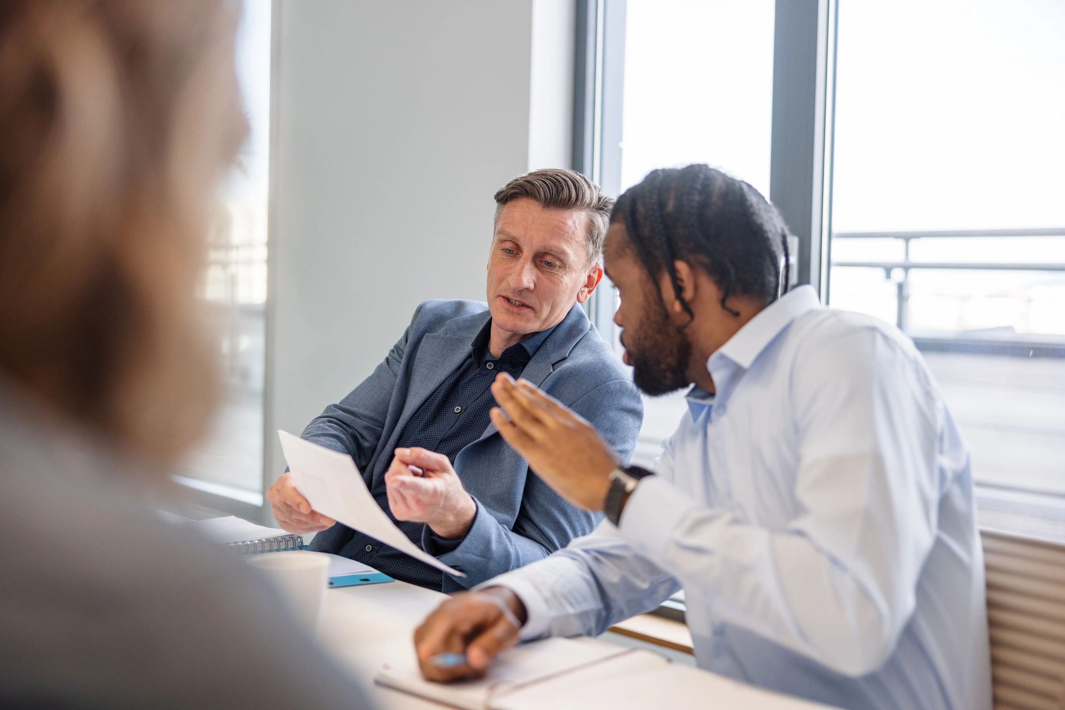 Two professionals discussing viewpoints in a conference room