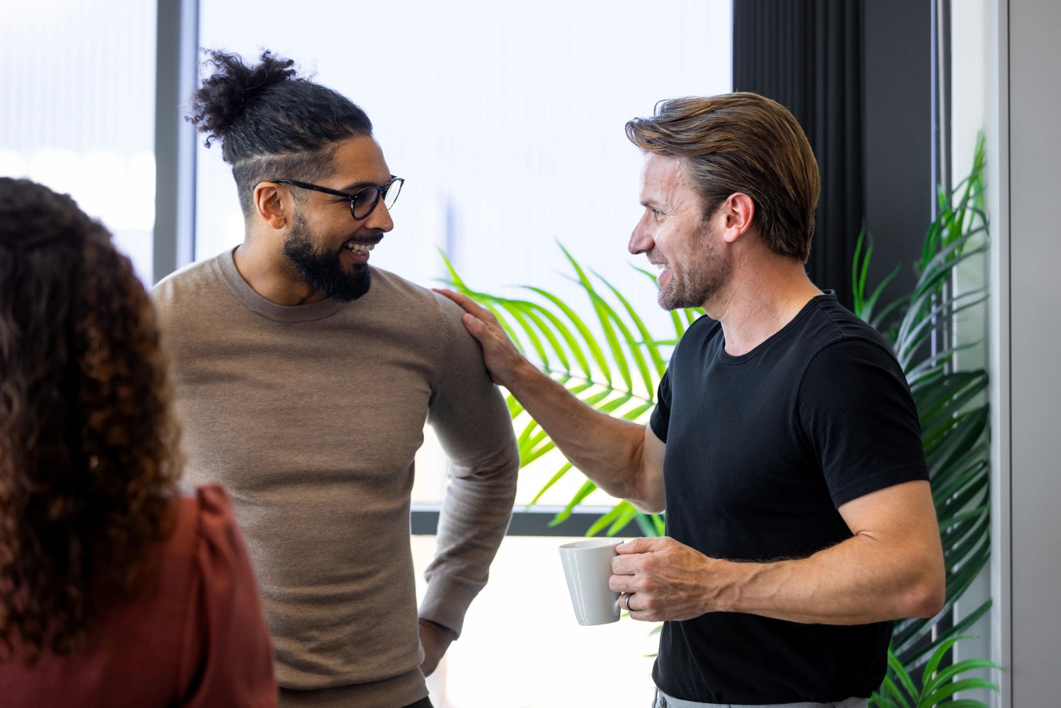 Two business professionals in conversation during a conference break